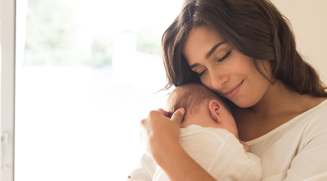 a person holding a baby in their arms
