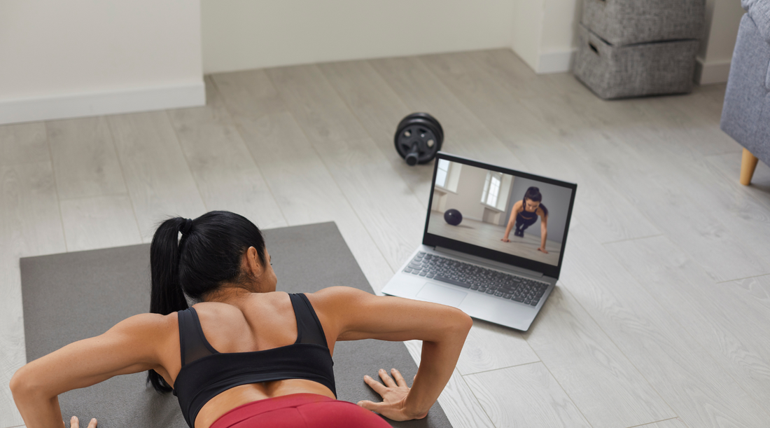 a person watching an exercise on laptop