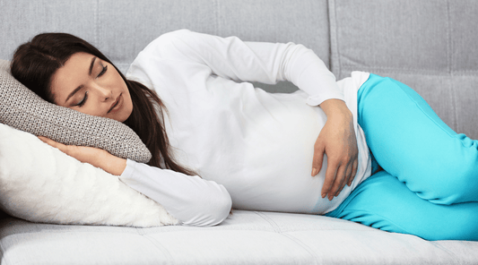 Sleeping pregnant women while holding her belly