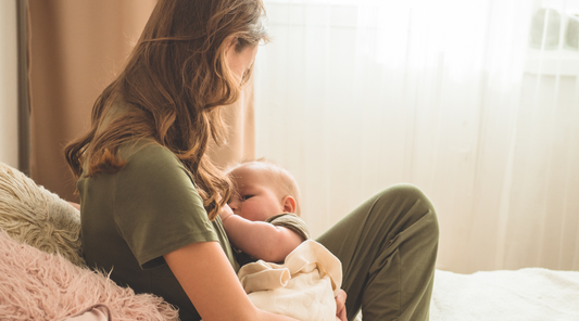 a person breastfeeding a baby